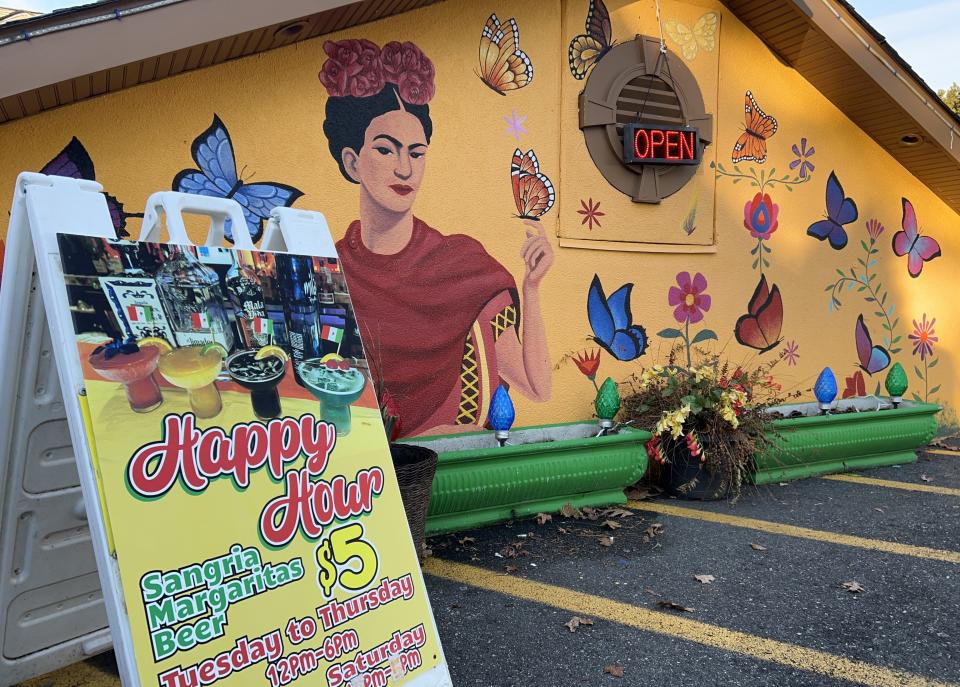 Sandwich board advertises $5 drink specials during happy hour at Cinco de Mayo Bar & Restaurant.