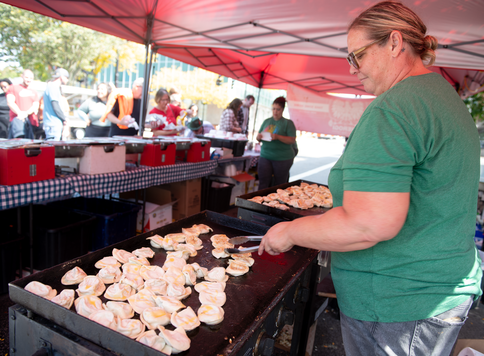 Autumn Johnston is The Pierogi Lady and flips pierogis on the grill at Main Street Kent's Oktoberfest on Saturday, Sept. 23.