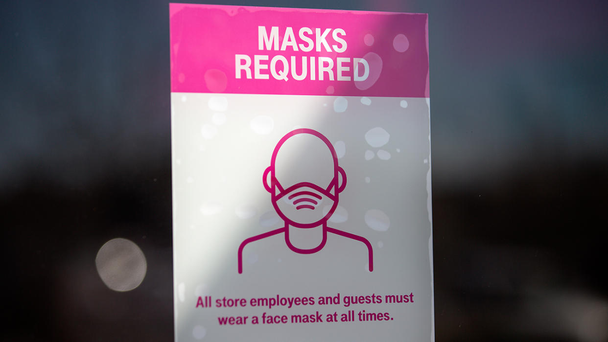 A Covid-19 restriction sign hangs inside a T-Mobile store on March 3, 2021 in Austin, Texas.(Montinique Monroe/Getty Images)