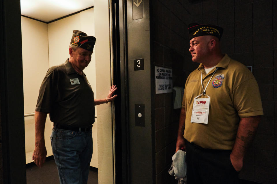 Michael Braman waits for a fellow veteran to exit the elevator at the VFW National Convention in Kansas City, Mo., on July 16, 2022. (Dominick Williams for NBC News)