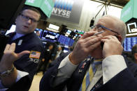 Trader Thomas Ferrigno, right, and specialist Gregg Maloney work on the floor of the New York Stock Exchange, Friday, Nov. 9, 2018. Stocks are falling as energy companies are dragged lower by the continuing plunge in crude oil prices. (AP Photo/Richard Drew)