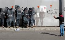 Protestor gestures as he speaks to the riot police during a protest against the political elite in Beirut