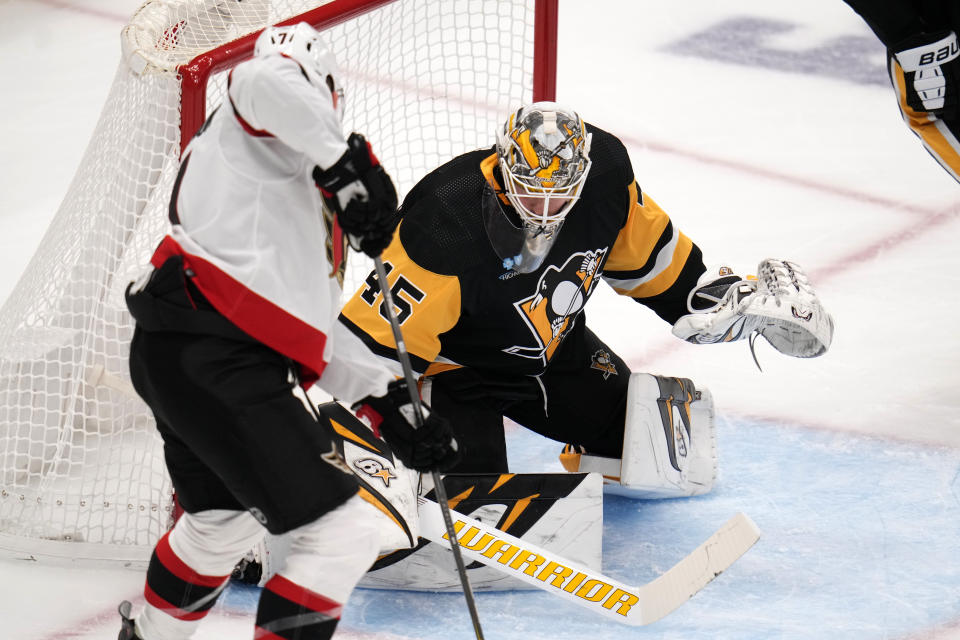 Ottawa Senators' Brady Tkachuk, left, collects a rebound off Pittsburgh Penguins goaltender Magnus Hellberg (45) and scores during the third period of an NHL hockey game in Pittsburgh, Saturday, Oct. 28, 2023. It was Tkachuk's second goal of the game. (AP Photo/Gene J. Puskar)