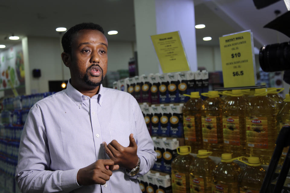 Lecturer in economics at Somalia University Ahmed Khadar Abdi Jama speaks about the soaring price of essential commodities during the holy month of Ramadan in an interview with Associated Press inside Hayat Mall in Mogadishu, Somalia, Saturday, March 25, 2023. This year's holy month of Ramadan coincides with the longest drought on record in Somalia. (AP Photo/Farah Abdi Warsameh).