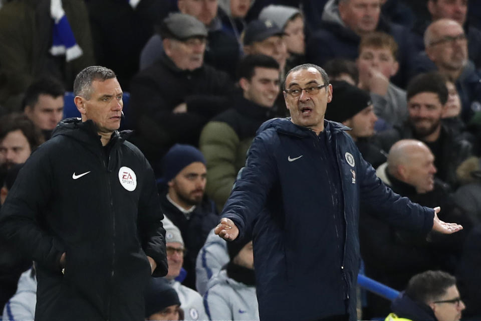 Chelsea head coach Maurizio Sarri gestures when looking at the fourth official during the English FA Cup fifth round soccer match between Chelsea and Manchester United at Stamford Bridge stadium in London, Monday, Feb. 18, 2019. (AP Photo/Alastair Grant)