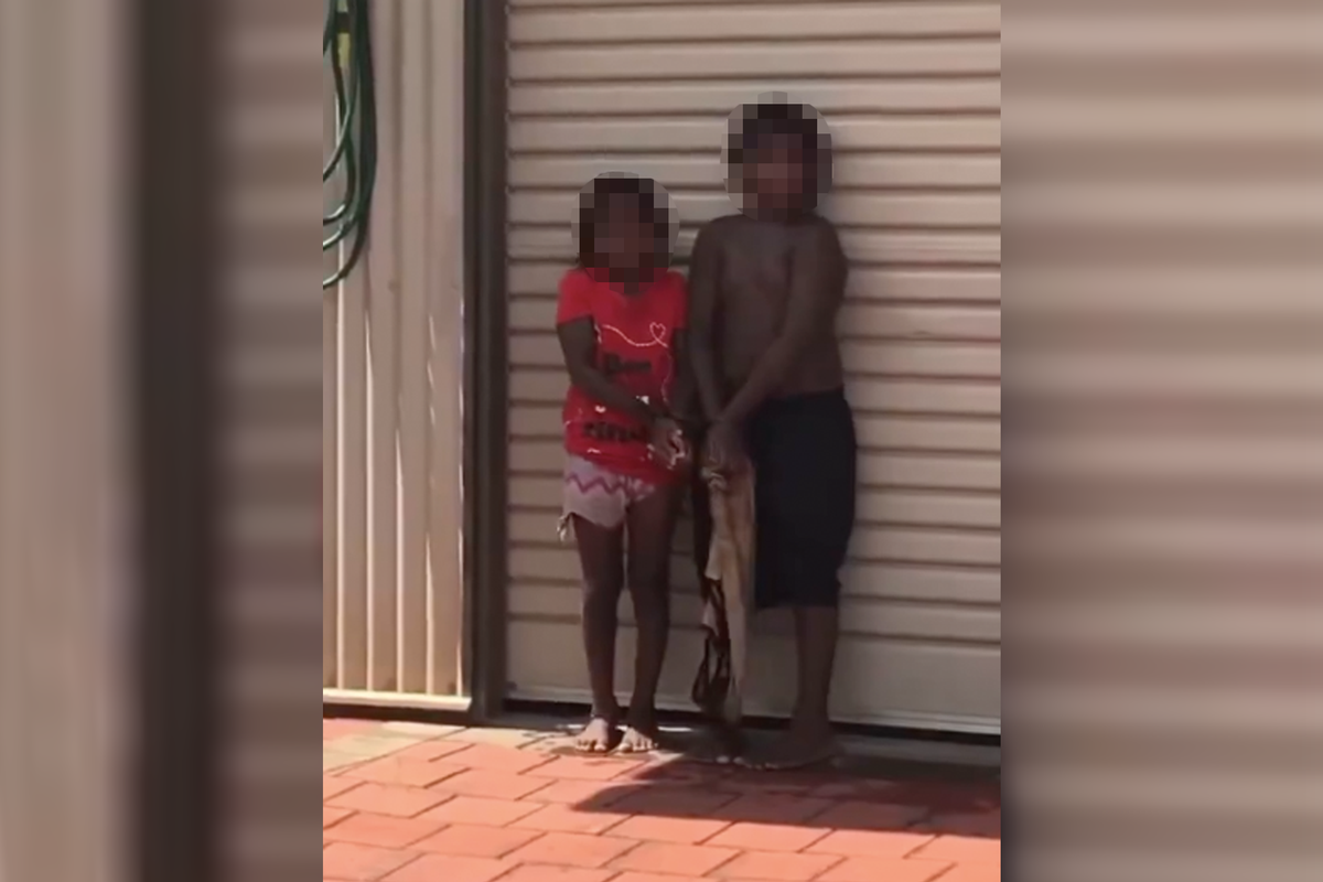 A screengrab from the viral video shows two aboriginal kids restrained in Broome, western Australia  (creedydono2440/X)