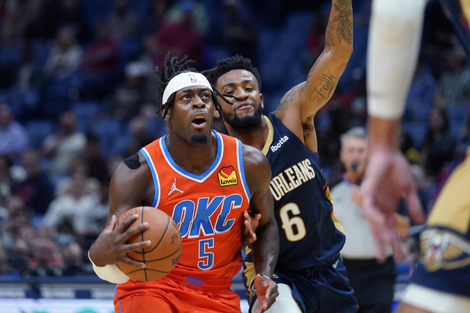 Oklahoma City Thunder forward Luguentz Dort (5) goes to the basket against New Orleans Pelicans guard Nickeil Alexander-Walker (6) in the first half of an NBA basketball game in New Orleans, Wednesday, Nov. 10, 2021. (AP Photo/Gerald Herbert)