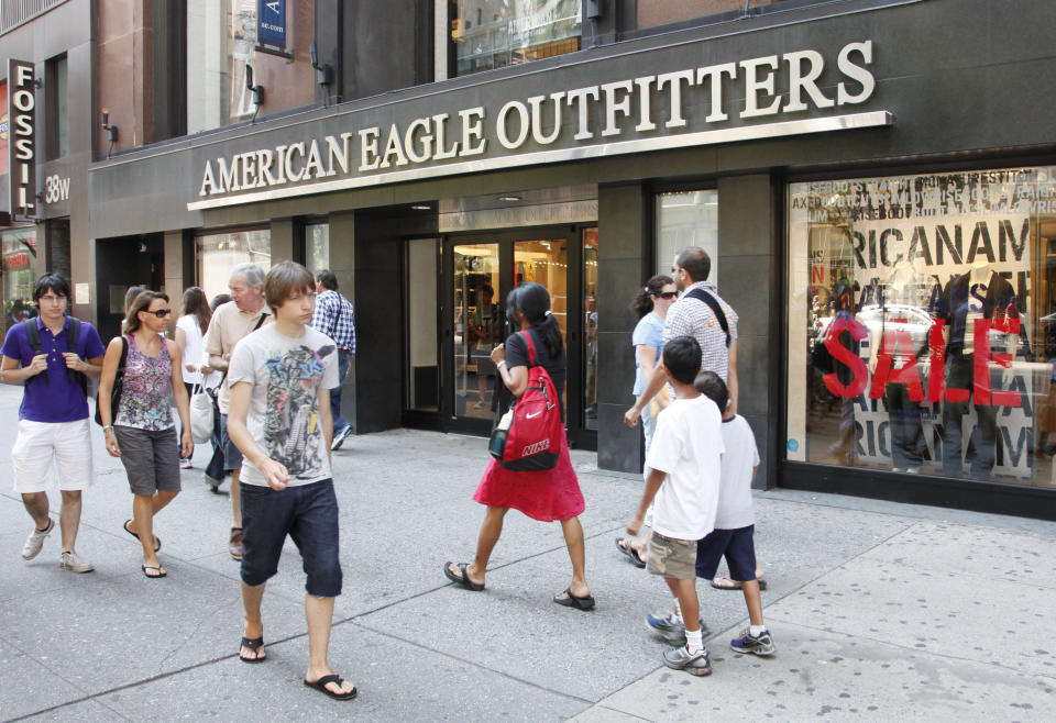 In this July 30, 2010 photo, youngsters pass an American Eagle Outfitters clothing store, in New York. Retail sales managed a modest increase in July after two consecutive declines, but the strength was concentrated in higher sales of autos and gasoline. Most other retailers saw their sales fall. (AP Photo/Mark Lennihan)