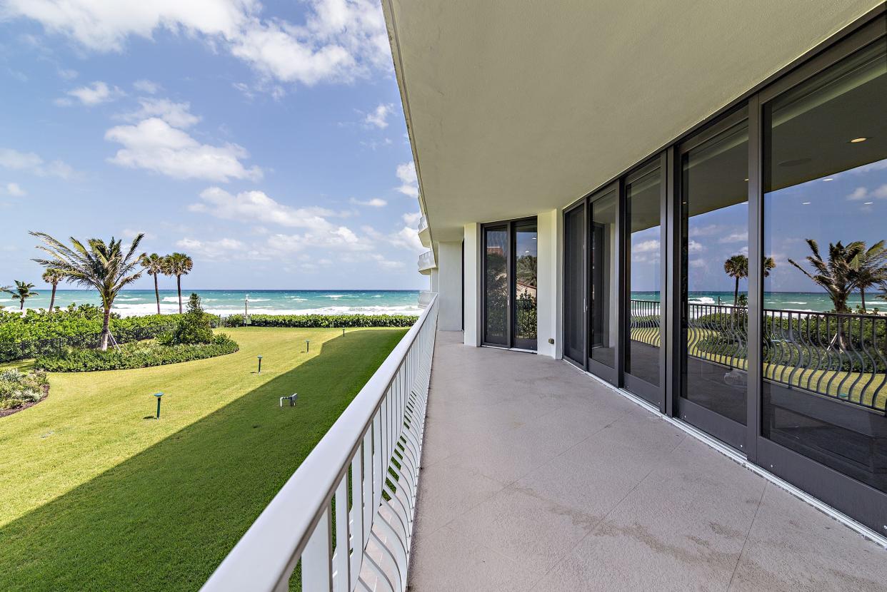 The balcony, which runs the length of the condo, views a side lawn while offering views of the Atlantic.