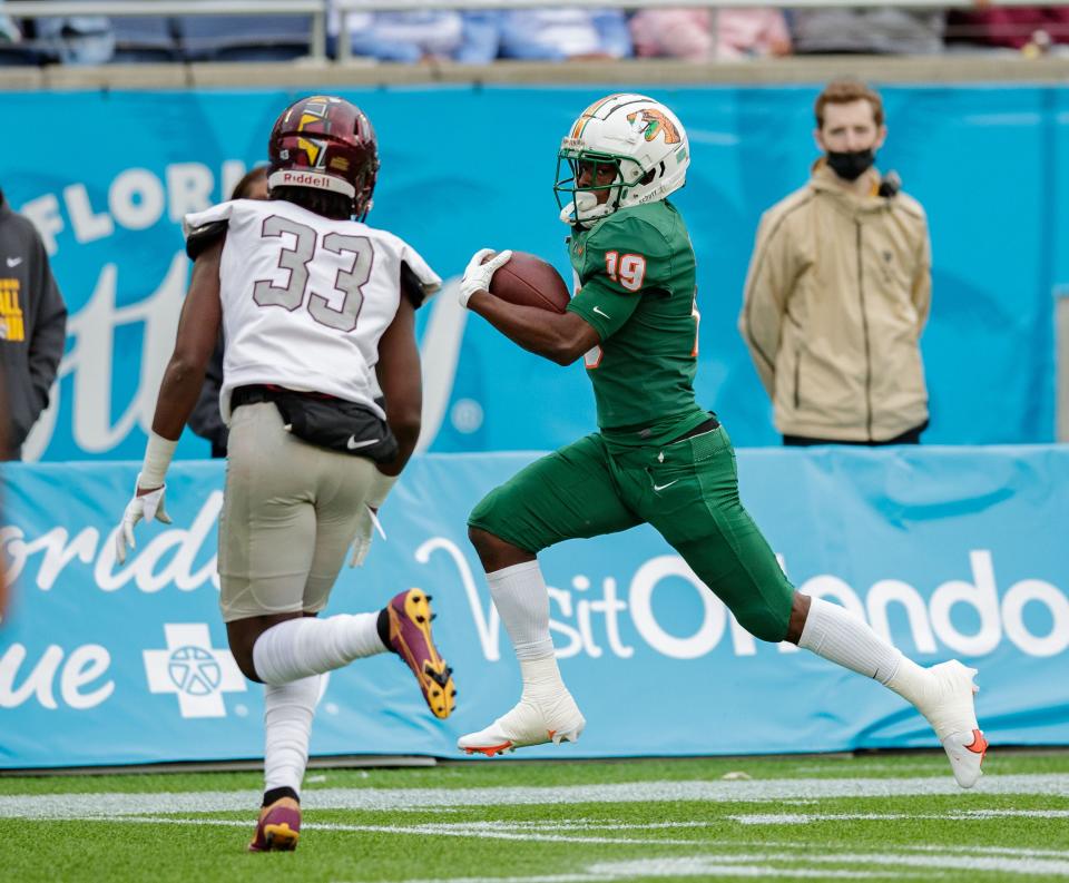 Florida A&M Rattlers wide receiver Xavier Smith (19) watches Bethune Cookman Wildcats cornerback Malik Franklin (33) as he continues to sprint to the end zone. The Florida A&M Rattlers lead the Bethune Cookman Wildcats 13-7 at the half during the Florida Classic at Camping World Stadium on Saturday, Nov. 20, 2021.