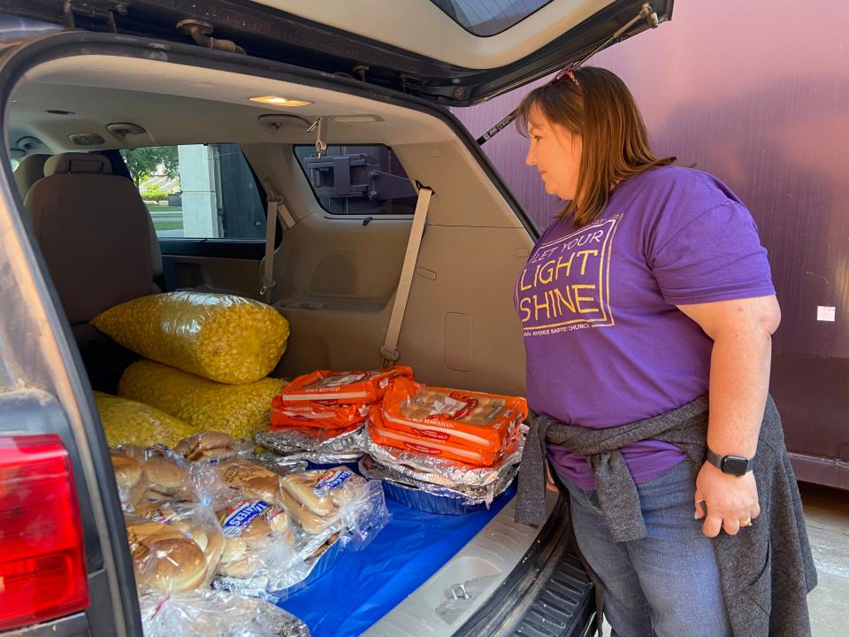 A volunteer from Michigan Baptist Church in Chickasha picks up left over from Oklahoma Memorial Stadium as part of Go See The City's Zero Waste initiative.