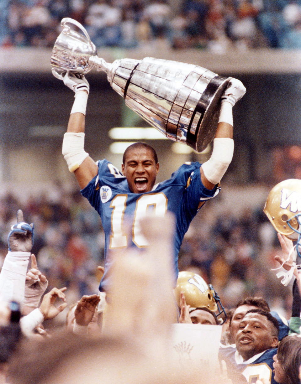 Winnipeg Blue Bombers defensive back Rod Hill lets out a victory yell as he raised the Grey Cup over his head following the Bombers' 50-11 victory over the Edmonton Eskimos in Vancouver in the 1990 Grey Cup. (The Canadian Press)