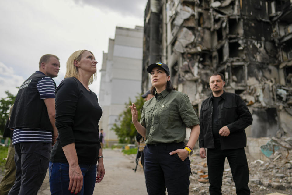 Ukraine's Prosecutor General Iryna Venediktova and U.S. ambassador to Ukraine Bridget Brink, left, survey a destroyed building in Borodyanka, outskirts of Kyiv, Ukraine, Saturday, June 4, 2022. (AP Photo/Natacha Pisarenko)