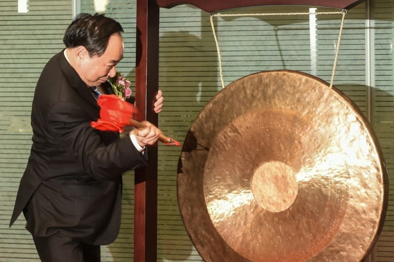 Li Guohua, Chairman of Postal Savings Bank of China (PSBC), bangs a gong during the company's listing on the Hong Kong Stock Exchange on September 28, 2016