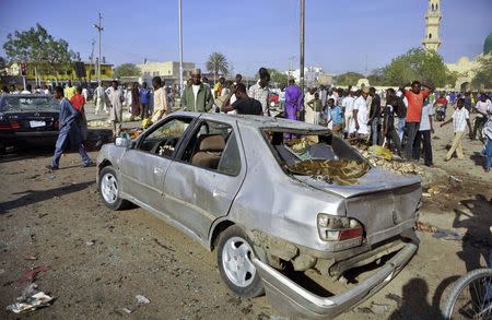 A car is seen damaged at a scene of multiple bombings at Kano Central Mosque November 28, 2014. REUTERS/Stringer