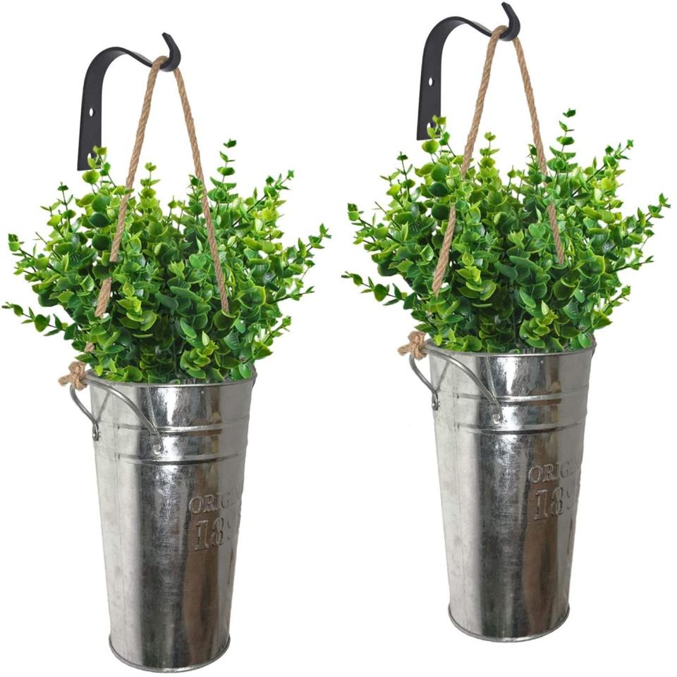 This set of planters come with a two galvanized buckets, two hemp ropes and two black metal hooks. You'll just need to add the flowers &mdash; either fresh or faux. <a href="https://amzn.to/34dUMJk" target="_blank" rel="noopener noreferrer">Find it for $21 at Amazon</a>.