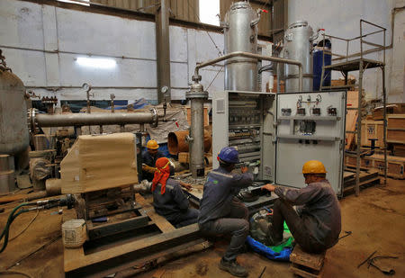 Employees work inside a research and development wing of Gas Lab Asia in New Delhi, India, March 8, 2017. REUTERS/Adnan Abidi