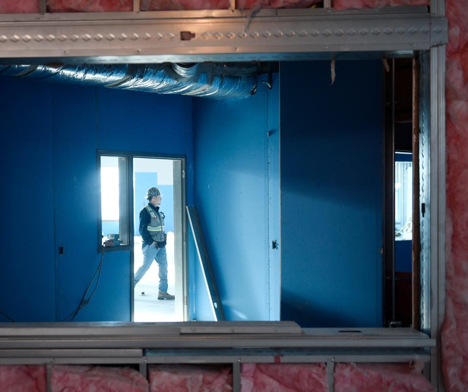 A construction worker walks through the new Carroll High School, Wednesday, Jan. 5, 2022.