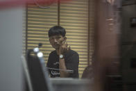 Anti-government protester Panupong Jadnok sits at a police station, Friday, Aug. 7, 2020, in Bangkok, Thailand. Political tensions in Thailand appeared to rising Friday, as pro-democracy activists vowed to step up the pace of protests against the government and police arrested some key figures in the movement’s recent demonstrations. (AP Photo/Sakchai Lalit)