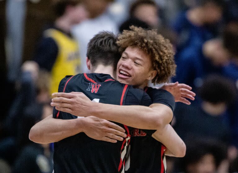 Sherman Oaks, CA - January 18: Harvard-Westlake High School forward Brady Dunlap, left, celebrates with teammate point guard Trent Perry after they beat Notre-Dame High School after two overtimes at Notre Dame High School in Sherman Oaks, Wednesday, Jan. 18, 2023. Harvard-Westlake won 85-78. (Allen J. Schaben / Los Angeles Times)