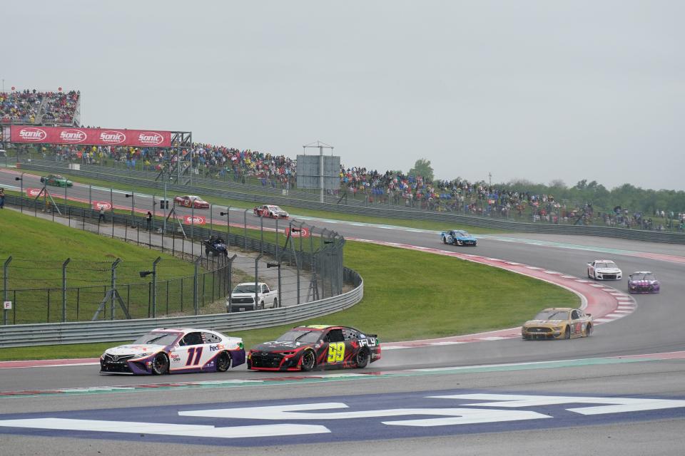 Denny Hamlin (11) leads Daniel Suarez (99) through turn two in the 2021 EchoPark Texas Grand Prix at Circuit of the Americas.