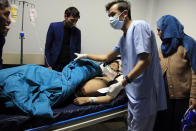 An Afghan receives treatment at hospital after suicide attack in Kabul, Afghanistan, Saturday, Oct. 24, 2020. The death toll from the suicide attack Saturday in Afghanistan's capital has risen that includes schoolchildren, the interior ministry said.. (AP Photo/Mariam Zuhaib)