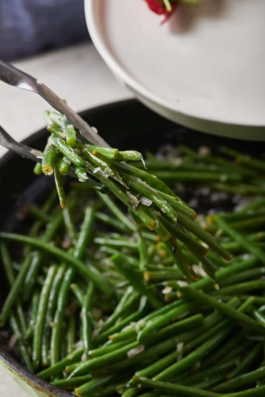 <p>Courtesy of Katie Workman</p><p>When green beans are at their freshest, you only need to cook them lightly with simple seasonings to make them perfect.</p><p><strong>Get the Recipe: </strong><a href="https://themom100.com/recipe/sauteed-green-beans-with-thyme-butter/" rel="nofollow noopener" target="_blank" data-ylk="slk:Sautéed Green Beans with Thyme Butter;elm:context_link;itc:0;sec:content-canvas" class="link rapid-noclick-resp"><strong>Sautéed Green Beans with Thyme Butter</strong></a></p>