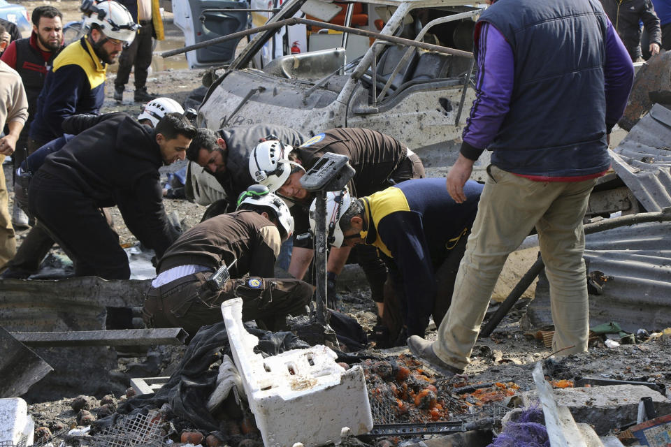 This photo provided by the Syrian Civil Defense White Helmets, which has been authenticated based on its contents and other AP reporting, shows members of the Syrian Civil Defense transporting an injured person after an airstrike hit the northern town of Maaret al-Numan, in Idlib province, Syria, Monday, Dec. 2, 2019. Syrian opposition activists say the airstrike on the market in Maaret al-Numan, a rebel-held town in the country's northwest, has killed at least 10 civilians. (Syrian Civil Defense White Helmets via AP)