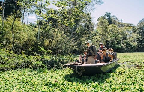 A skiff in the river with people on board - Credit: SporledraArt @SPOART