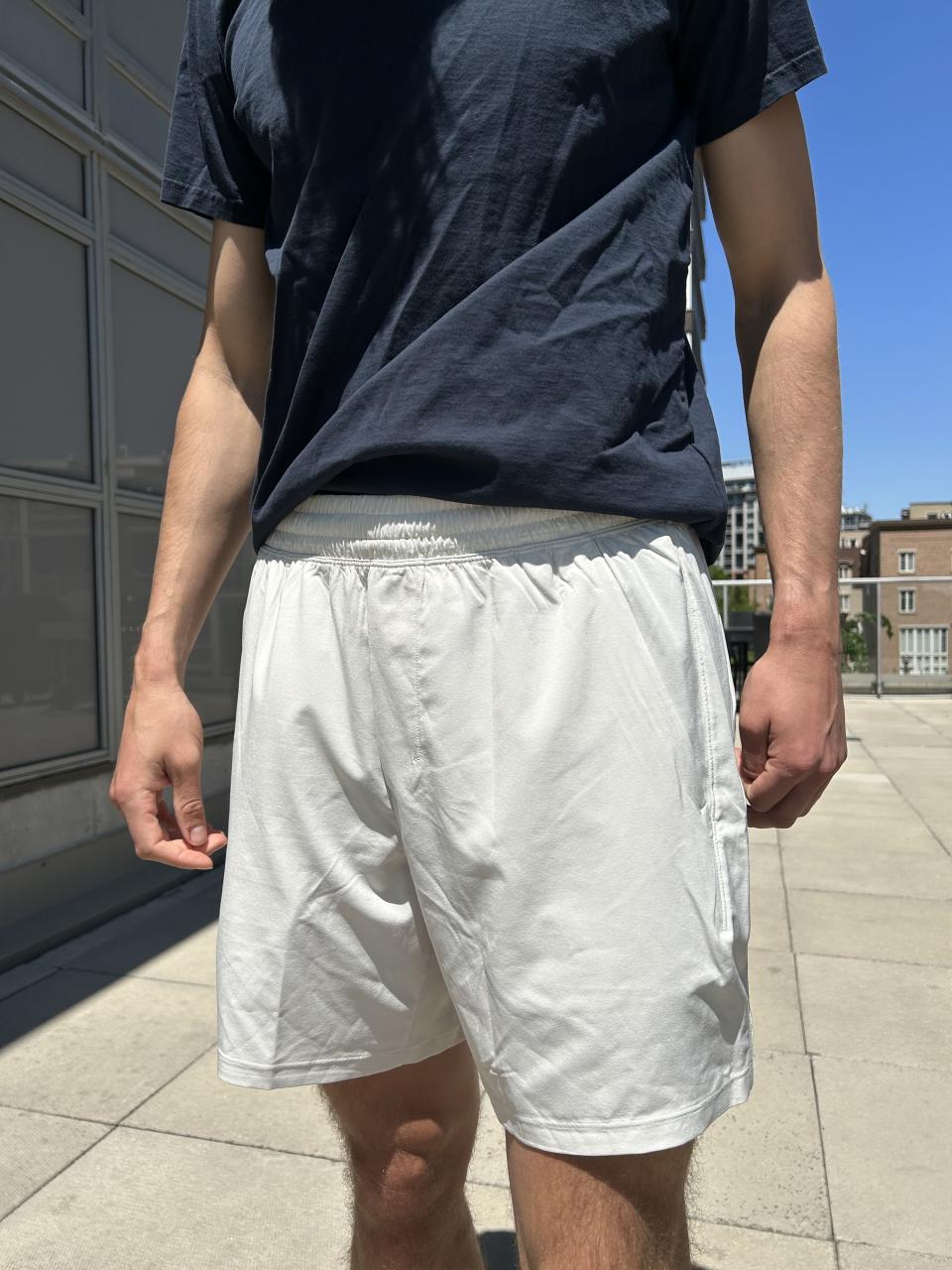 man wearing navy blue t-shirt and white biking shorts