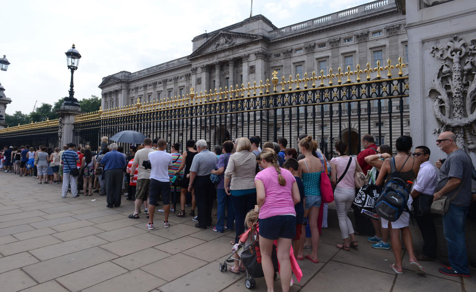 Members of the public queuing to look at the official announcement that the Duke and Duchess of Cambridge have had a baby boy, outside Buckingham Palace in London.