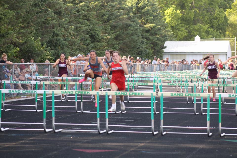 Addison's Molly Brown leads the pack in the 100-meter high hurdles during the Lenawee County Track and Field Championships at Sand Creek,