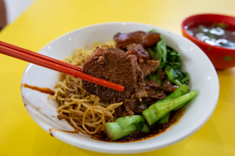 Chopsticks holding beef brisket