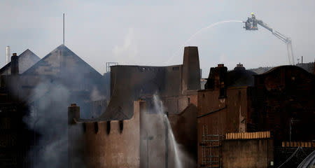 Firefighters attend to a blaze at the Mackintosh Building at the Glasgow School of Art, which is the second time in four years, Glasgow, Scotland, Britain June 16, 2018. REUTERS/Russell Cheyne