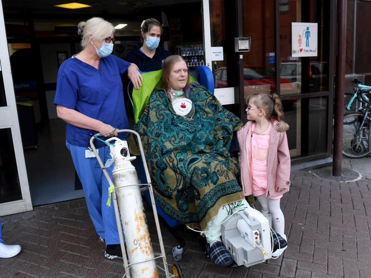 Jason Kelk is believed to be one of the UK's longest-suffering COVID patients, pictured with hospital staff and his granddaughter Felicity Wager, five. (SWNS)