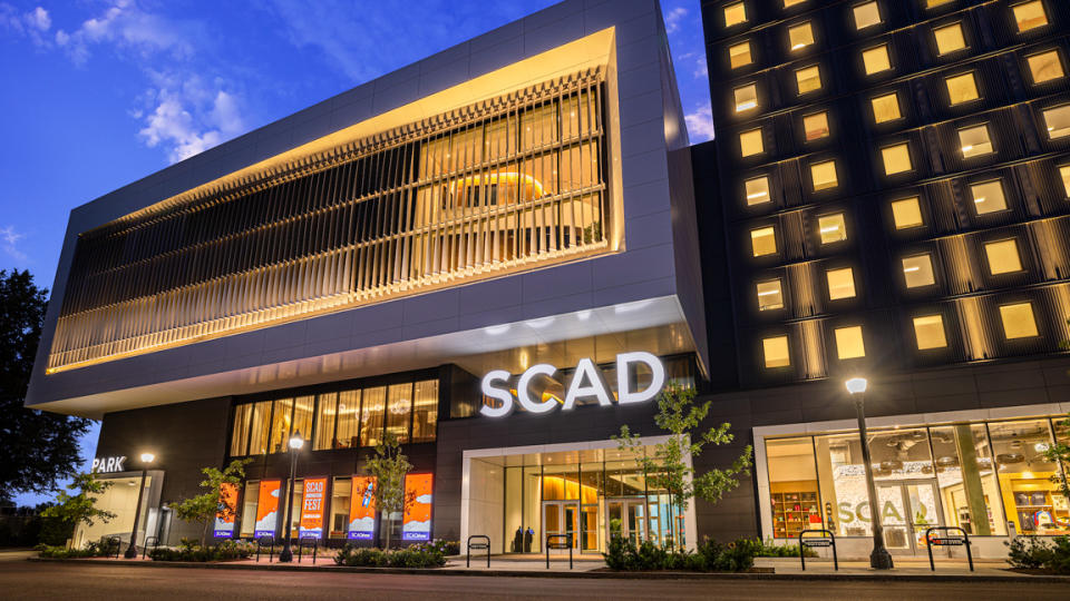 AI art and filmmaking; a building at night with the word SCAD on it