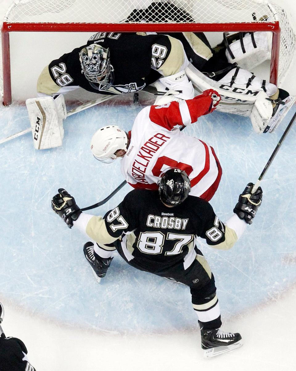 Penguins goalie Marc-Andre Fleury (29) keeps the puck from crossing the goal line against Red Wings left wing Justin Abdelkader (8) as Penguins center Sidney Crosby (87) defends during the second period of the Wings' 6-3 loss Thursday in Pittsburgh.