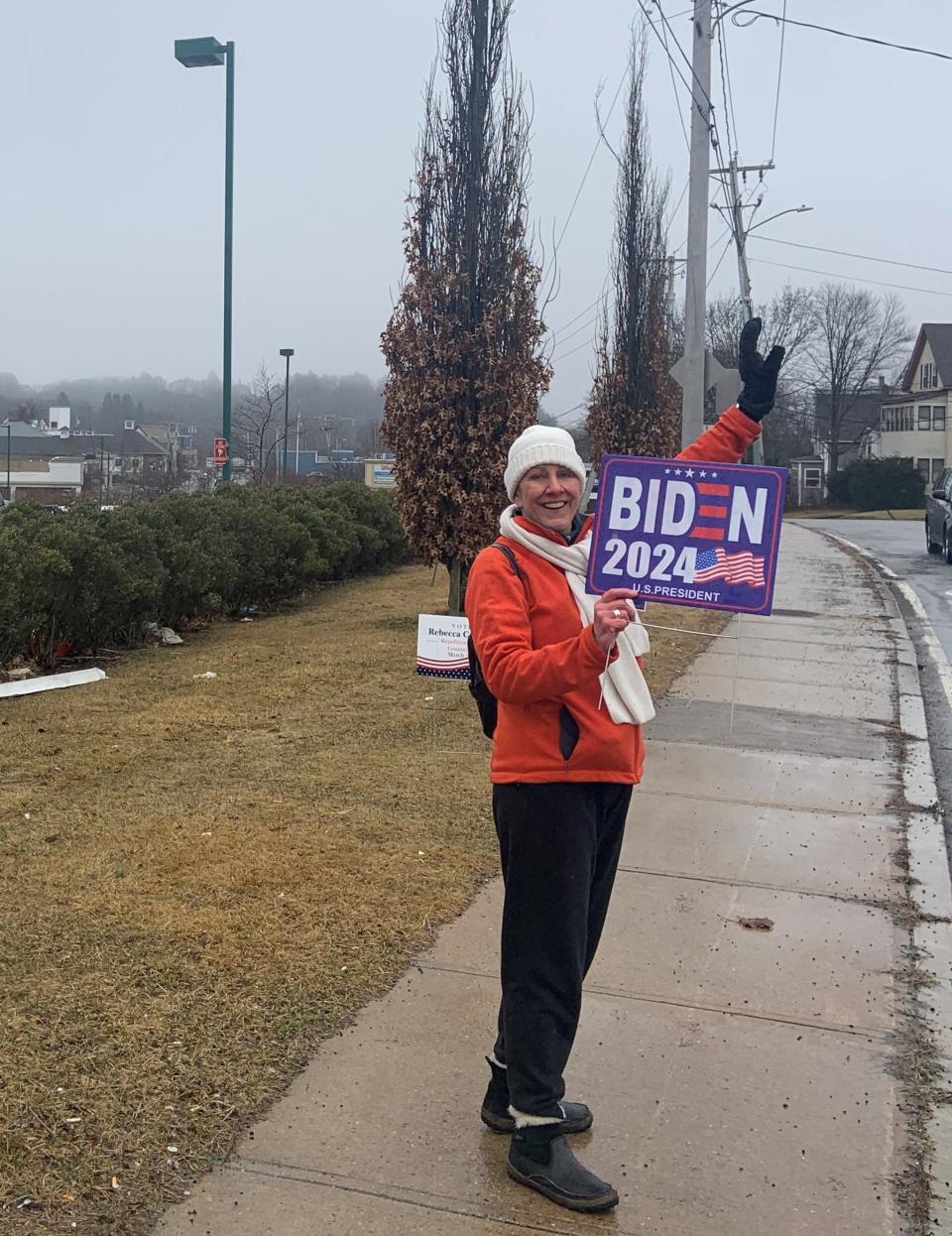 A BIden supporter braved the drizzly weather to hold a sign outside of Ward 4 at the Gardner Police Department on Super Tuesday.