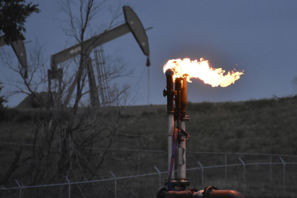 FILE - A flare to burn methane from oil production is seen on a well pad near Watford City, North Dakota, Aug. 26, 2021. The Biden administration is ramping up efforts to reduce methane emissions, targeting the oil and gas industry for its role in global warming even as President Joe Biden has pressed energy producers for more oil drilling to lower prices at the gasoline pump. Biden was set to announce a supplemental rule Friday, Nov. 11, 2022, cracking down on emissions of methane as he attends a global climate conference in Egypt.(AP Photo/Matthew Brown, File)