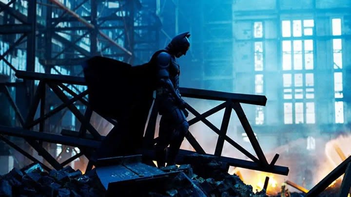 Batman standing among wreckage in The Dark Knight
