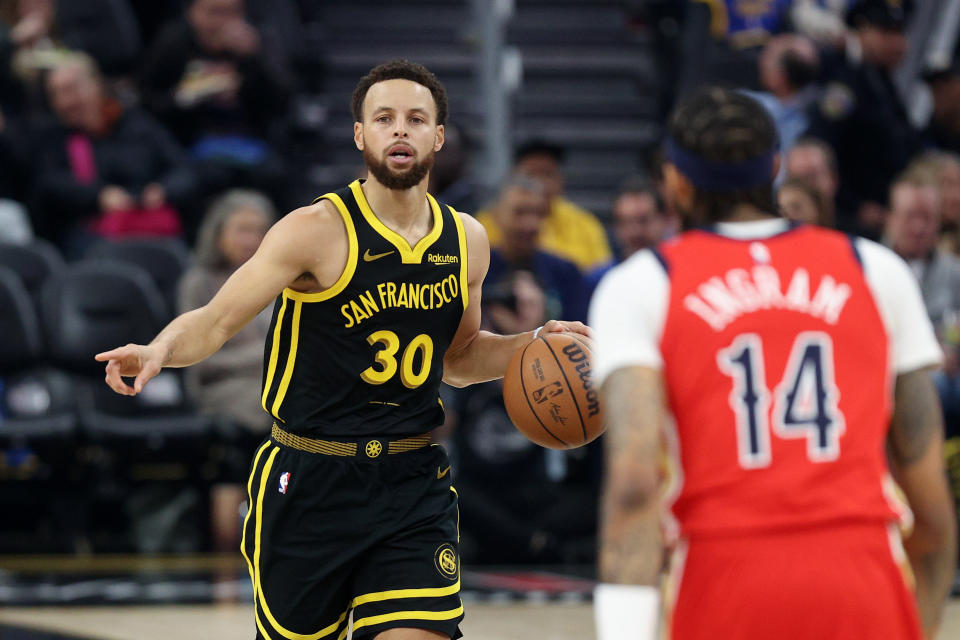 SAN FRANCISCO, CALIFORNIA - JANUARY 10: Stephen Curry #30 of the Golden State Warriors is guarded by Brandon Ingram #14 of the New Orleans Pelicans at Chase Center on January 10, 2024 in San Francisco, California. NOTE TO USER: User expressly acknowledges and agrees that, by downloading and or using this photograph, User is consenting to the terms and conditions of the Getty Images License Agreement.  (Photo by Ezra Shaw/Getty Images)