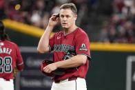 Arizona Diamondbacks pitcher Paul Sewald (38) has issues with the pitch com system during the ninth inning of a baseball game against the Cincinnati Reds Wednesday, May 15, 2024, in Phoenix. (AP Photo/Darryl Webb)
