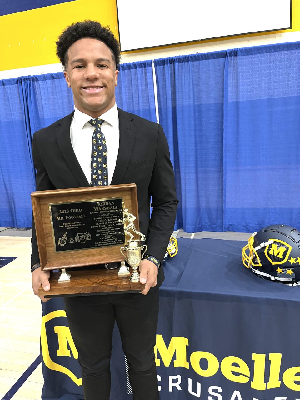 Moeller senior Jordan Marshall with the Mr. Football trophy as Moeller senior Jordan Marshall was given the trophy for Ohio Mr. Football by the Ohio High School Athletic Assocation Dec. 6, 2023 in the Moeller gymnasium.