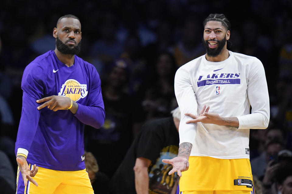 Los Angeles Lakers' LeBron James, left, and Anthony Davis react to a 3-point basket against the Memphis Grizzlies by a teammate during the second half in Game 6 of first-round NBA basketball playoff series Friday, April 28, 2023, in Los Angeles. The Lakers won 125-85. (AP Photo/Jae C. Hong)