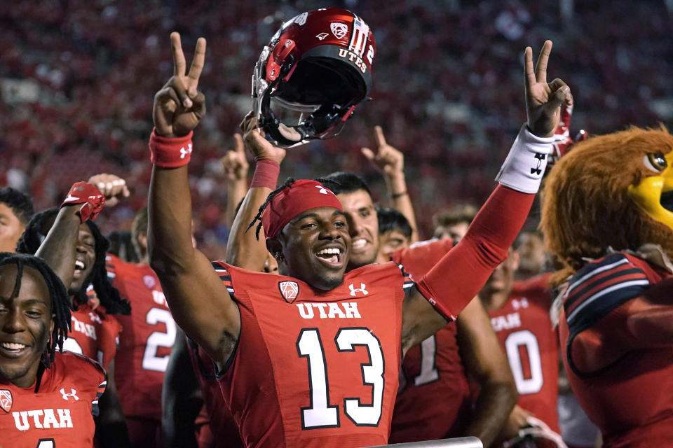 Utah quarterback Nate Johnson (13) celebrates with teammates after their NCAA college football game against Florida on Thursday, Aug. 31, 2023, in Salt Lake City. (AP Photo/Rick Bowmer)