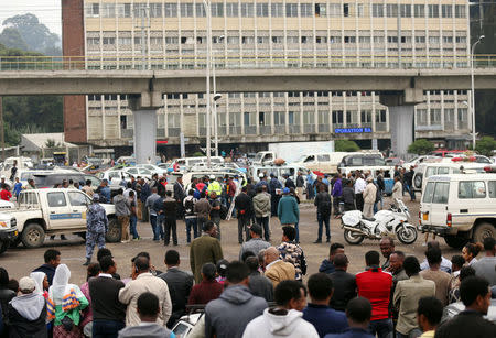 Bystanders watch the scene where EthiopiaÕs Grand Renaissance Dam Project Manager Simegnew Bekele was found dead in his car in Addis Ababa, Ethiopia July, 26, 2018 REUTERS/Tiksa Negeri