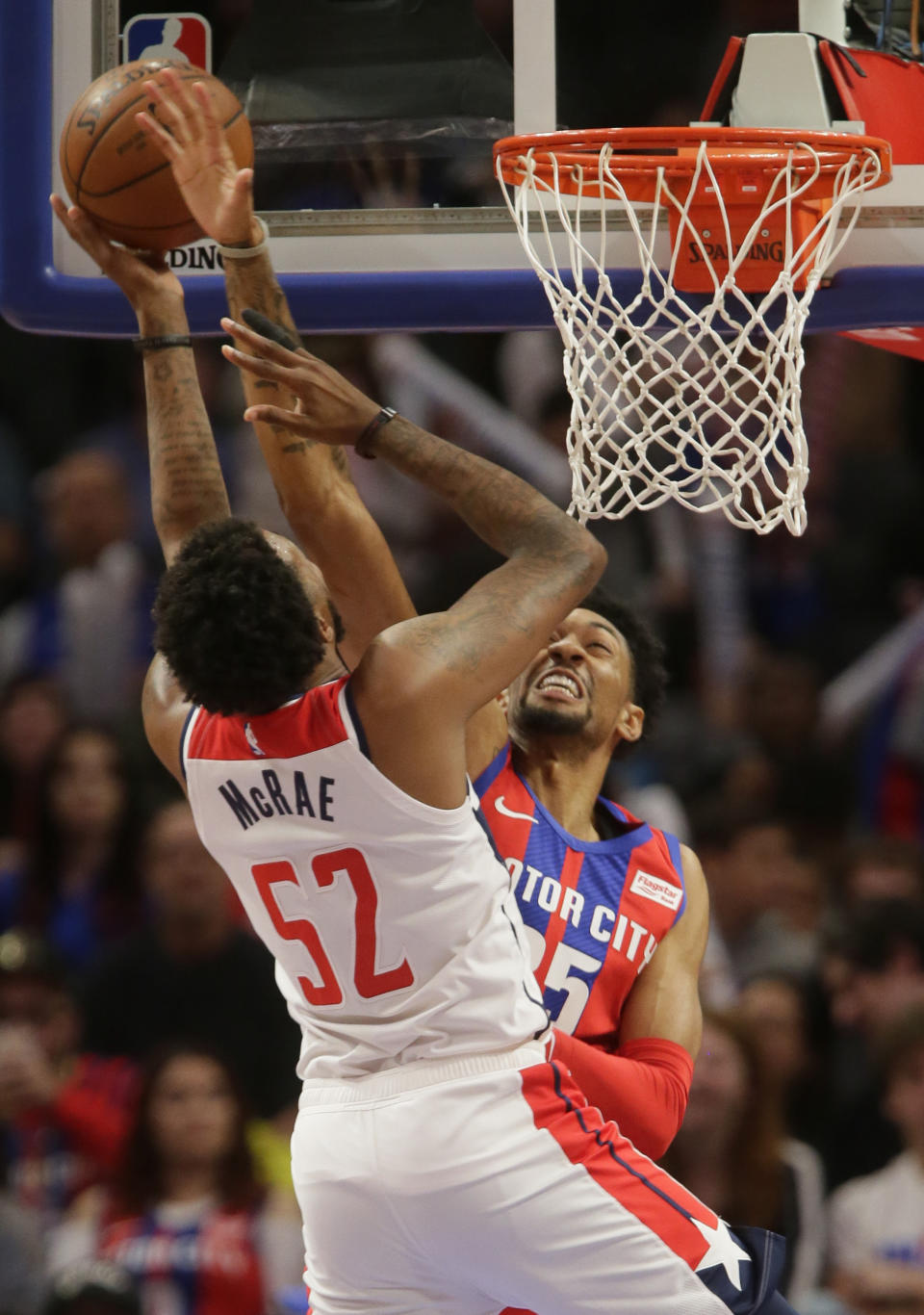 Detroit Pistons forward Christian Wood, right, defends against a shot by Washington Wizards guard Jordan McRae (52) during the first half of an NBA basketball game Thursday, Dec. 26, 2019, in Detroit. (AP Photo/Duane Burleson)