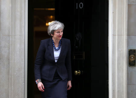 Britain's Prime Minister Theresa May walks out of 10 Downing Street to greet Portugal's Prime Minister Antonio Costa in London, April 10, 2018. REUTERS/Hannah Mckay