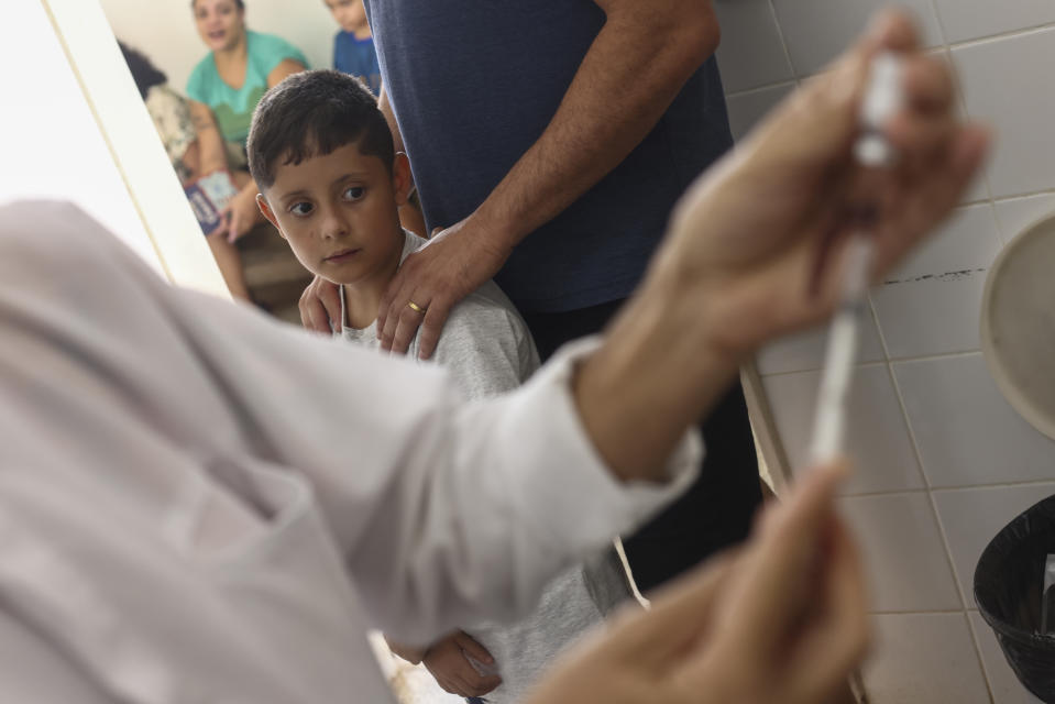 A dose of the dengue vaccine is prepared for youths at a health center in the Ceilandia neighborhood on the outskirts of Brasilia, Brazil, Friday, Feb. 9, 2024. The vaccine is available only for children between 10 and 14 years old. (AP Photo/Luis Nova)