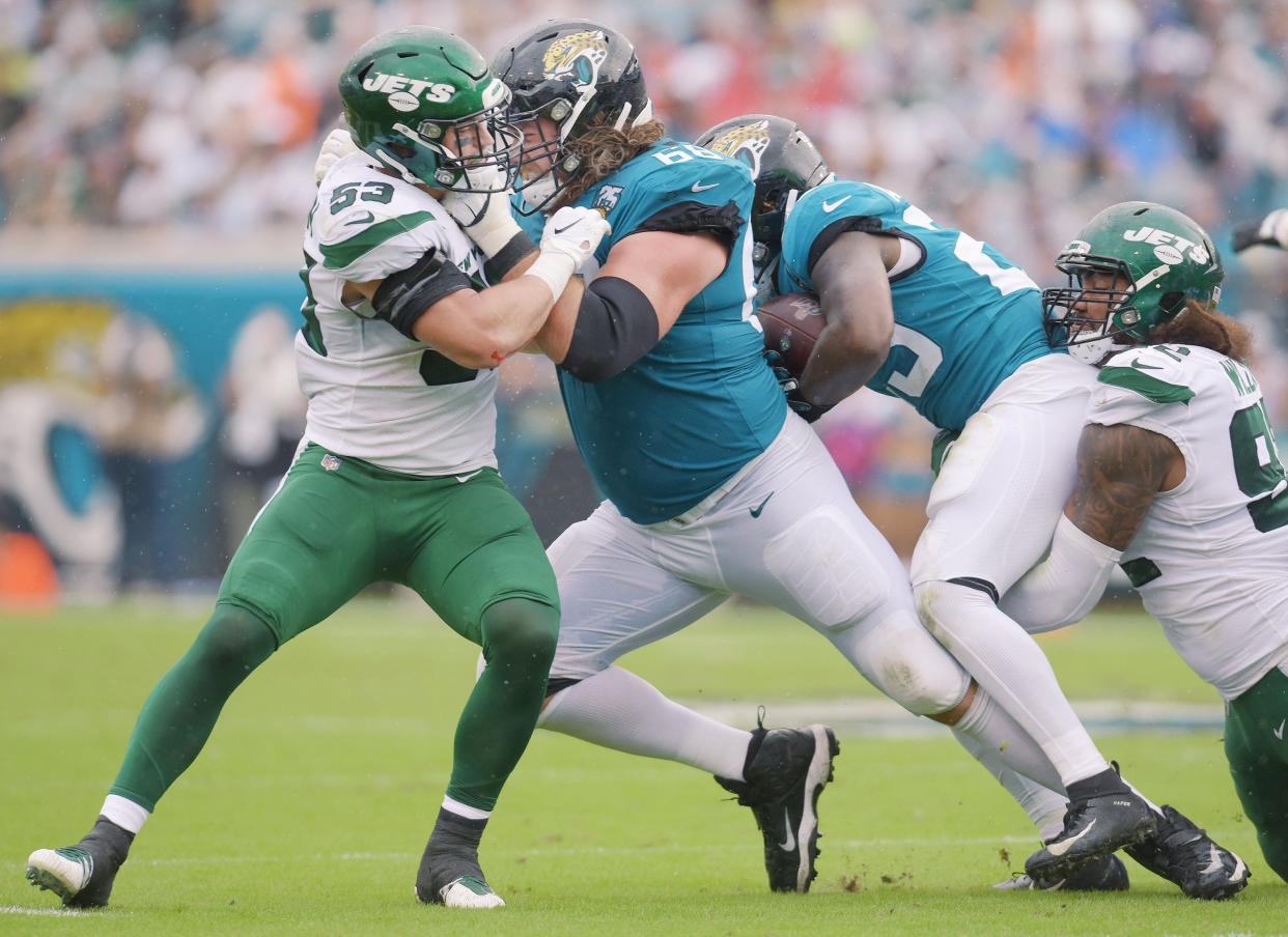 Jacksonville Jaguars offensive guard Andrew Norwell (68) battles with New York Jets linebacker Blake Cashman (53) to create running room for Jacksonville Jaguars running back Ryquell Armstead (23) during second quarter action. The Jacksonville Jaguars hosted the New York Jets at TIAA Bank Field in Jacksonville, Florida, October 27, 2019. The Jaguars went into the half with a 19 to 7 lead. [Bob Self/Florida Times-Union]